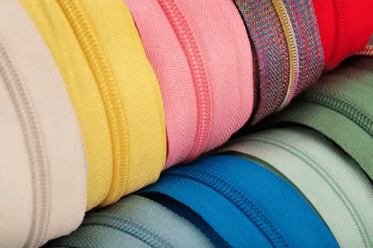 Rolls of MAM coil zipper chain in cream, yellow, pink, red, blue and sage