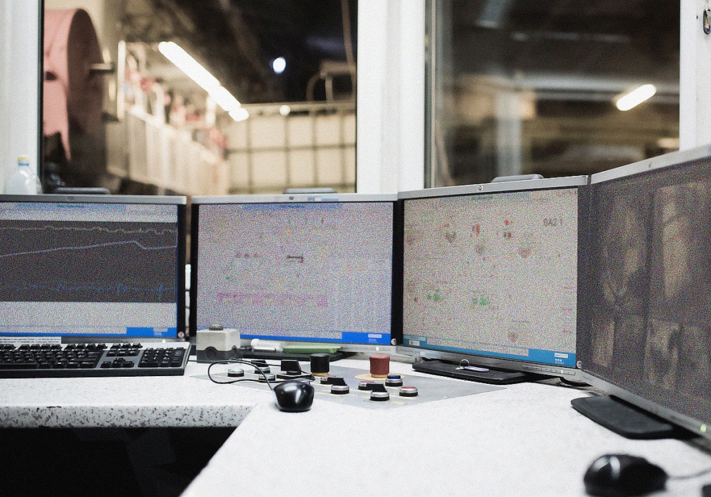 Control-room screens monitoring continuous board production